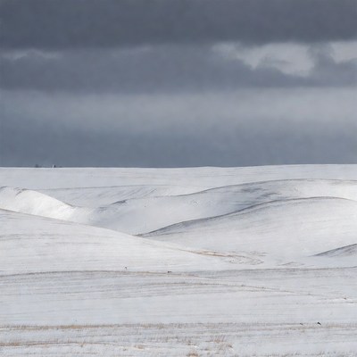 Snowy Hills Under Gray Clouds