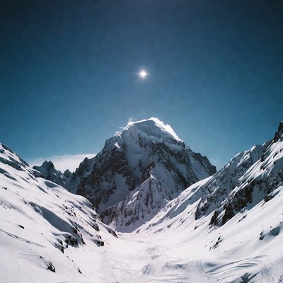 Snowy Mountain Peak with Sun
