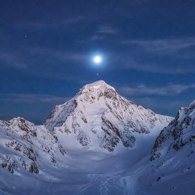 Snowy Mountain Peak Under Full Moon
