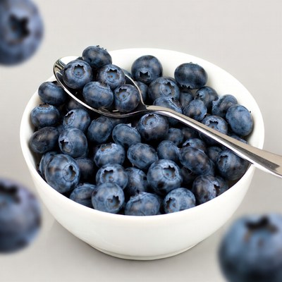 Blueberries in white bowl with spoon