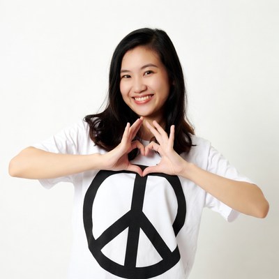 Asian girl making heart with peace shirt