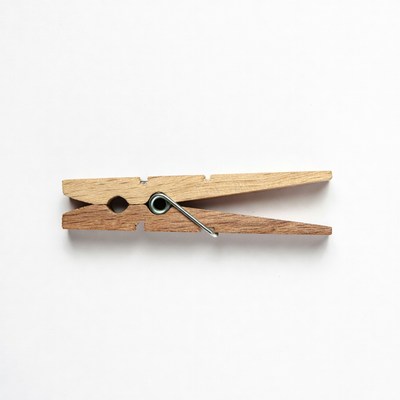 Wooden clothespin on white background