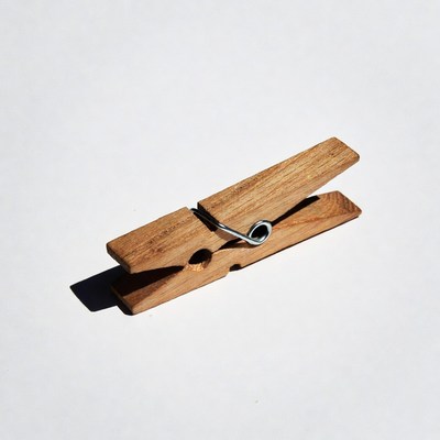 Wooden clothespin on white background