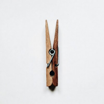 Wooden clothespin on white background