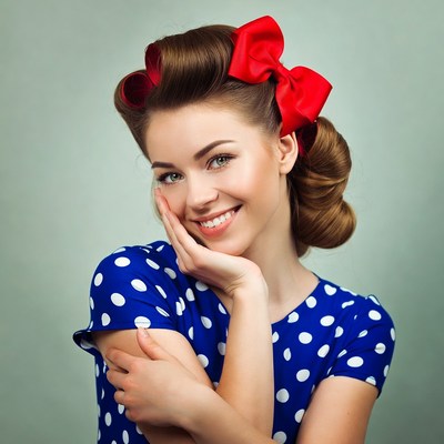Smiling pinup woman with red bow