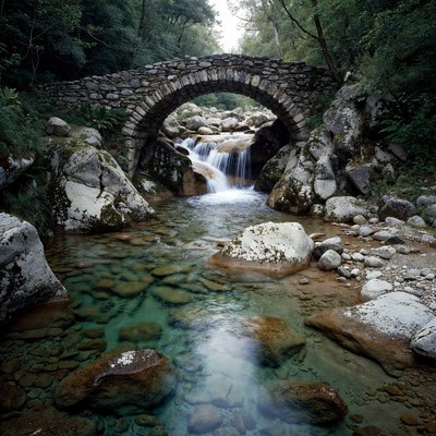Stone Arch Bridge over Forest Waterfall