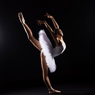 Asian ballerina performing arabesque pose