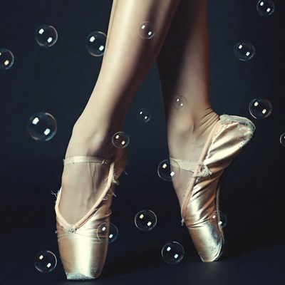 Ballerina in pointe shoes with bubbles
