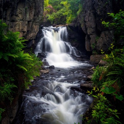 Waterfall cascading between rocky cliffs