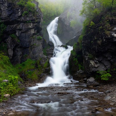 Waterfall cascading between rocky cliffs