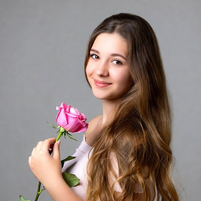 Girl holding pink rose