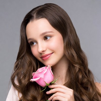 Girl holding pink rose