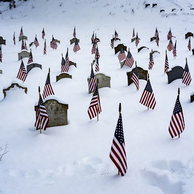 American Flags on Snowy Cemetery Graves