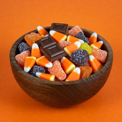 Wooden bowl of candy corn and chocolate