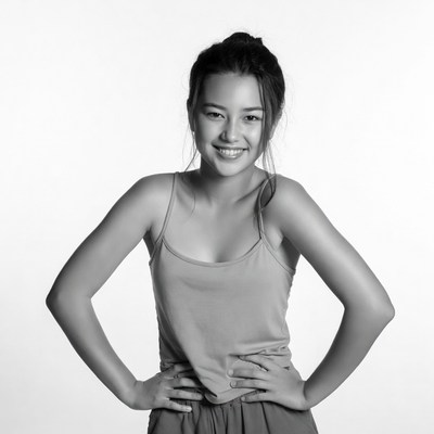 Asian woman smiling with hands on hips