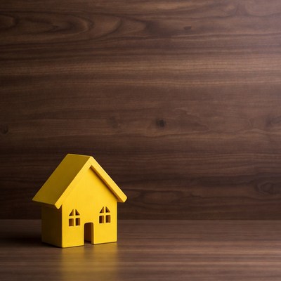 Yellow toy house on wood