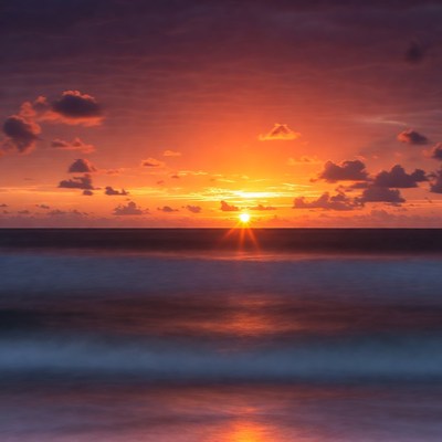 Sunset over ocean with waves