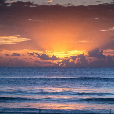 Sunrise over ocean with sun rays