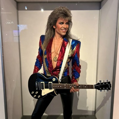 Man with mullet playing guitar