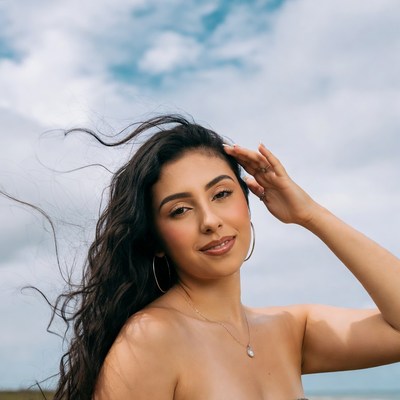 Latina woman hand on head outdoors