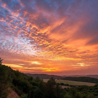 Vibrant Sunset Over Hilly Landscape