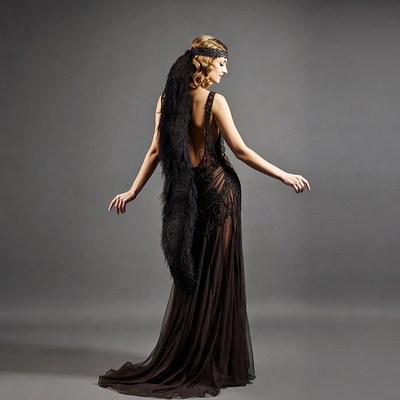 Woman in black feathered flapper gown