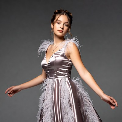 Young woman in feathered satin dress