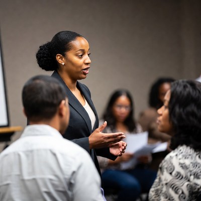 African-American woman leading business meeting