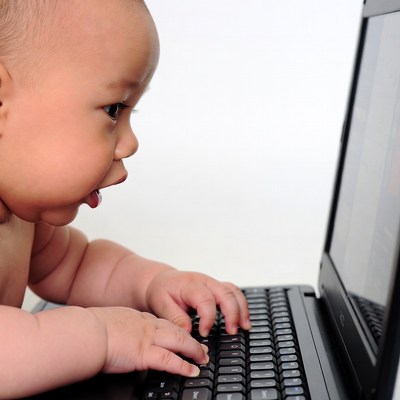 Baby typing on laptop
