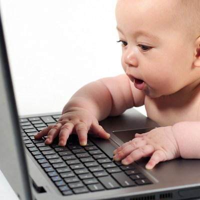 Baby typing on laptop