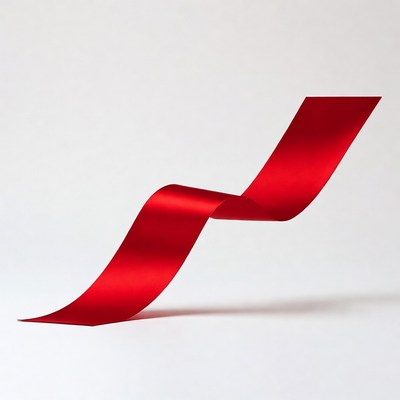 Red ribbon curling on white background