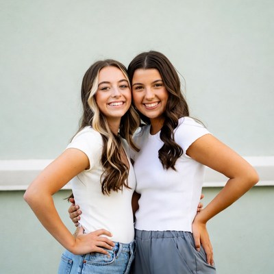 Two smiling teenage girls hugging