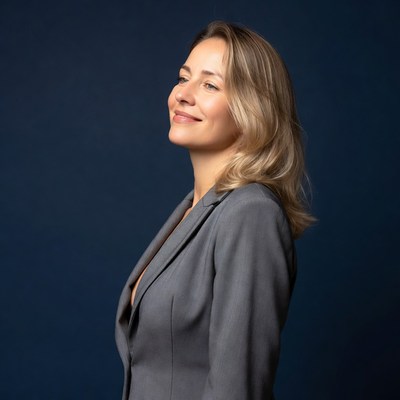 Blonde woman smiling in gray suit