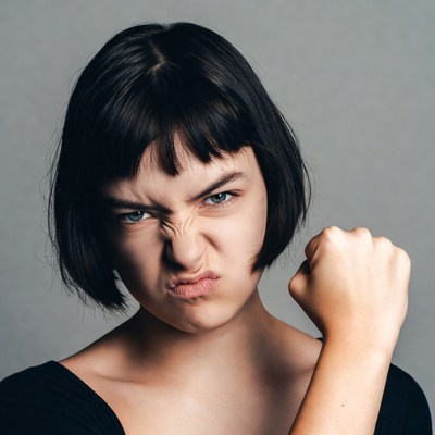 Woman making angry grimace with fist