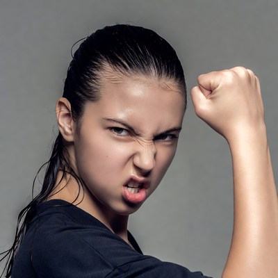 Angry woman clenching fist