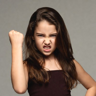 Angry girl clenching fist