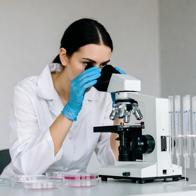 Woman scientist using microscope