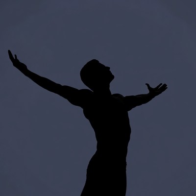 Man silhouette with arms raised
