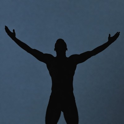 Muscular man silhouette arms raised