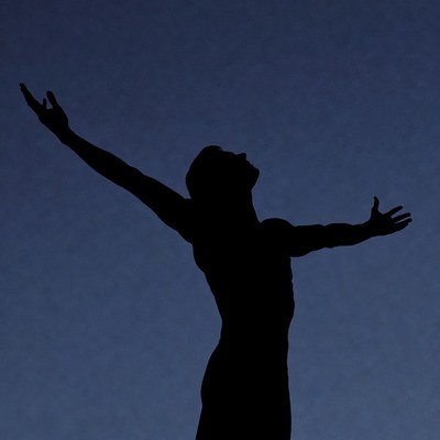 Man silhouette with arms raised