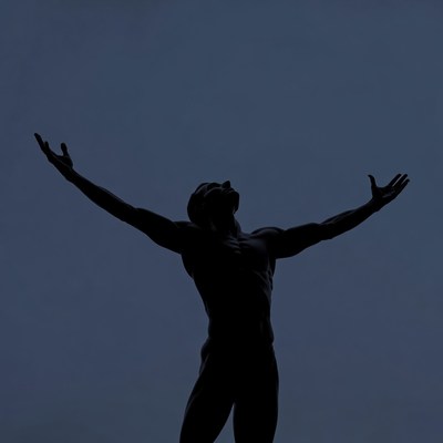 Silhouette of muscular man with arms raised