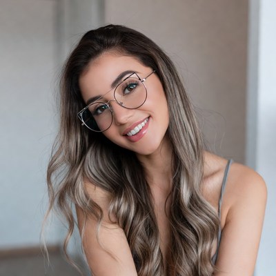 Smiling woman with glasses and wavy hair