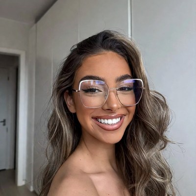 Woman smiling in oversized glasses