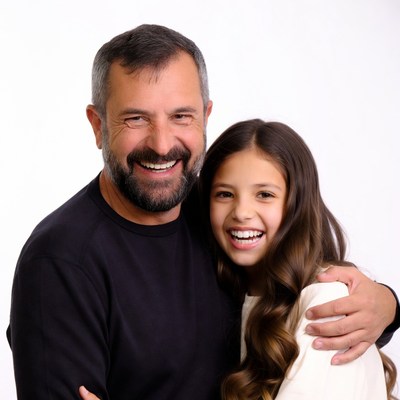 Smiling father hugging daughter