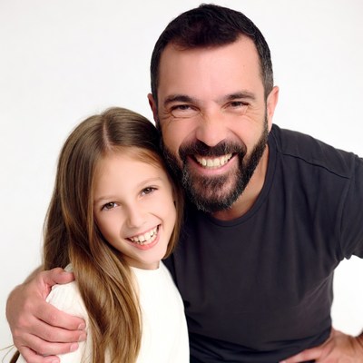 Father hugging smiling daughter