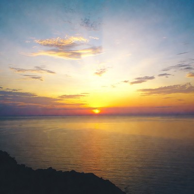 Sunset over ocean from cliff