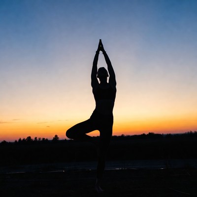 Woman doing tree pose yoga silhouette
