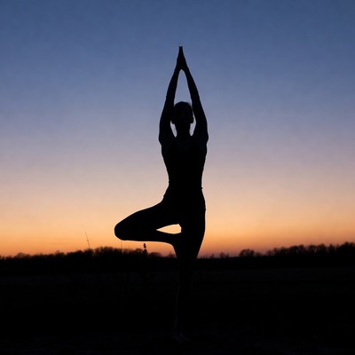 Silhouette of woman in tree pose yoga