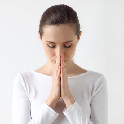 Woman praying with hands clasped