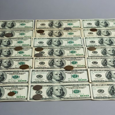 Stack of US Dollars and Coins